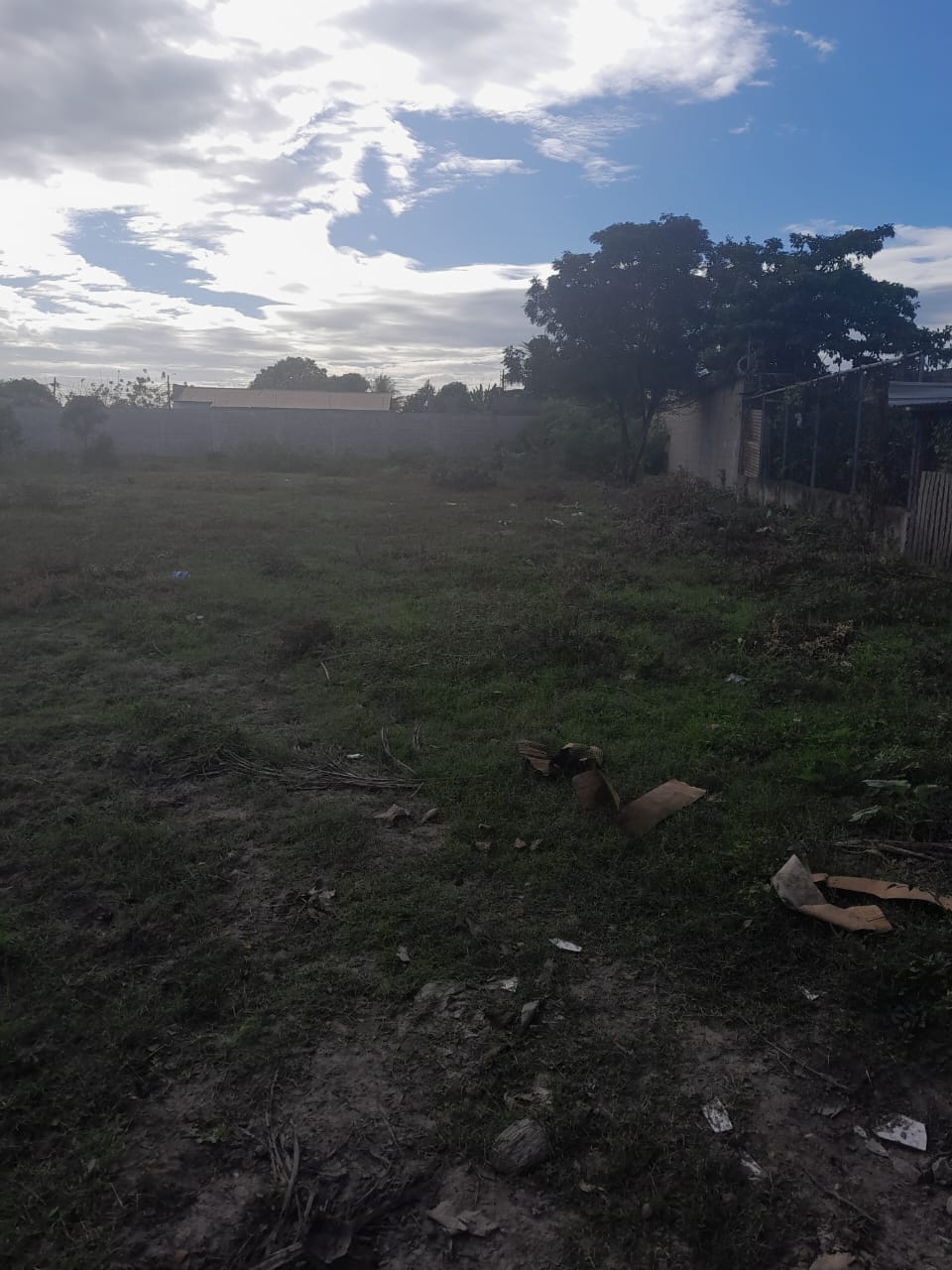 Vista lateral del terreno amplio conformado por tres lotes, con cielo despejado, ubicado cerca de la carretera RN-23.
